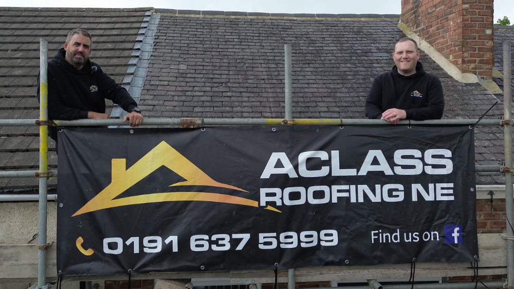 A Class Roofing NE roofers fitting new grey tiles on a North East house roof from scaffolding